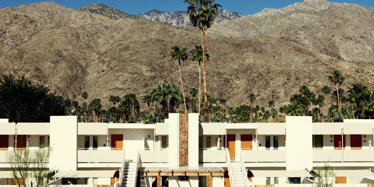 Outside view of Ace Hotel with a view of mountains and palm trees behind